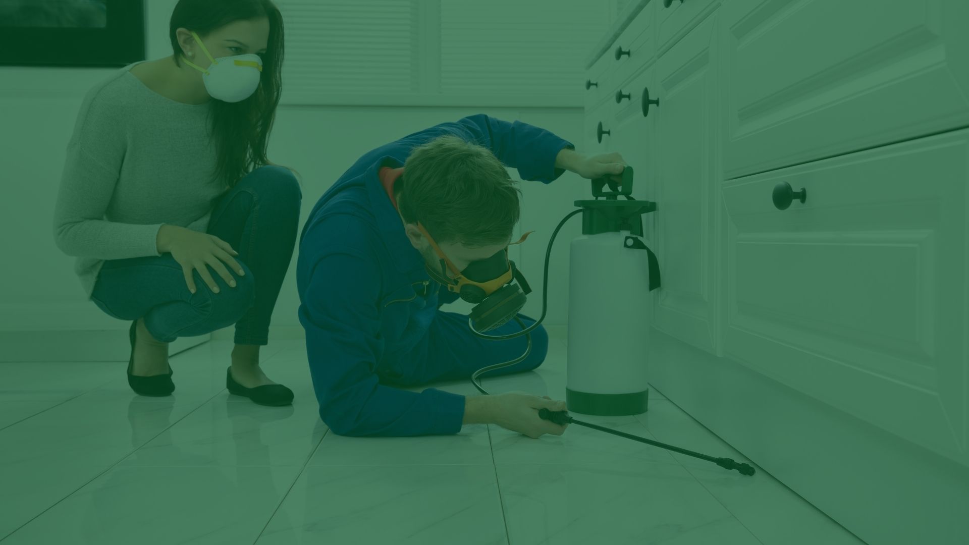 exterminator-on-the-floor-spraying-pesticide-under-kitchen-cabinets-charleston-sc